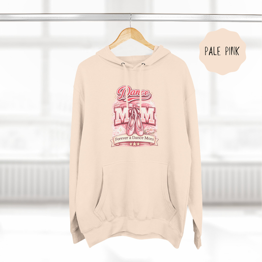 Pale pink dance mom hoodie hanging on wooden hanger with ballet themed illustrated design.