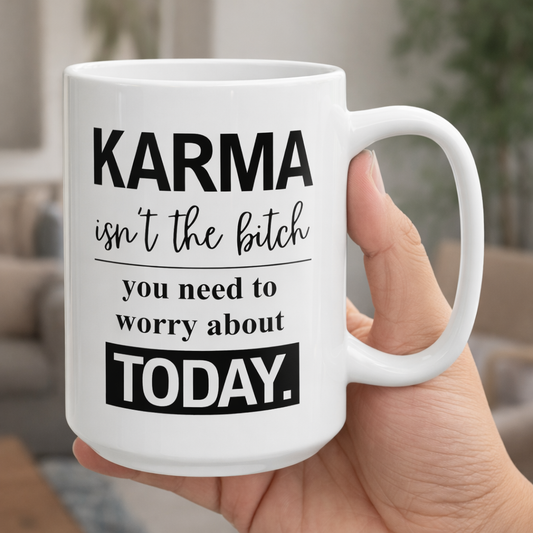White ceramic coffee mug with bold sarcastic quote “Karma isn’t the bitch you need to worry about today” printed in black typography.