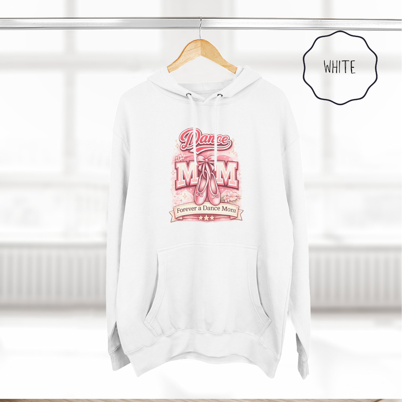 White dance mom hoodie hanging on wooden hanger with ballet themed illustrated design.