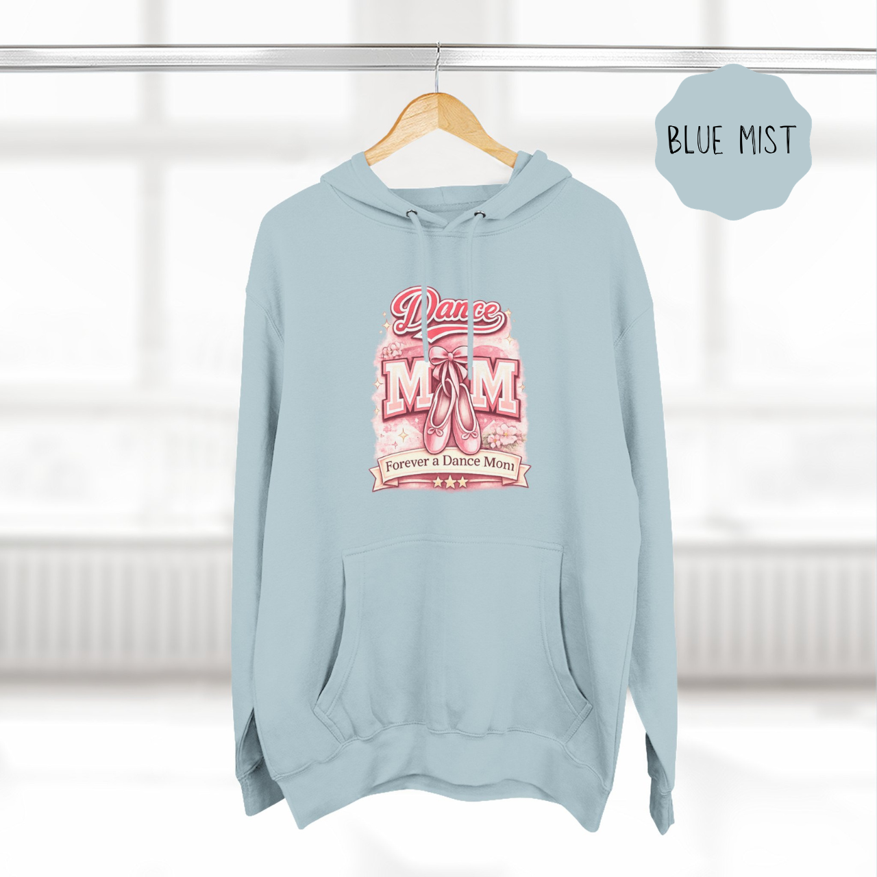 Blue Mist dance mom hoodie hanging on wooden hanger with ballet themed illustrated design.