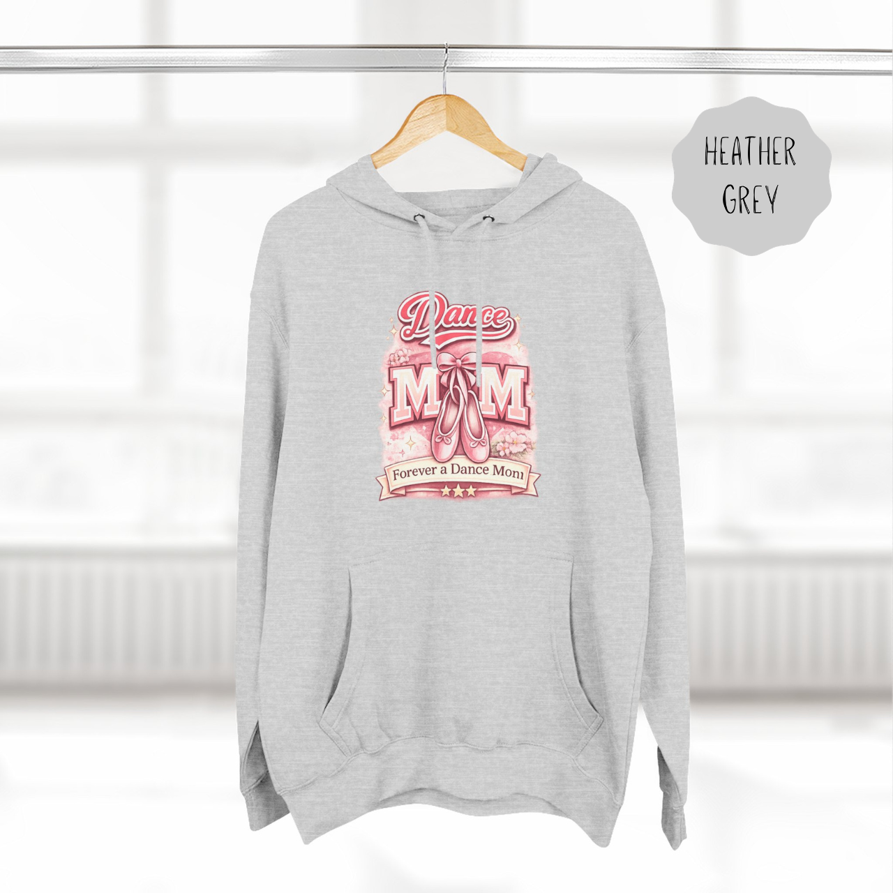 Heather Grey dance mom hoodie hanging on wooden hanger with ballet themed illustrated design.