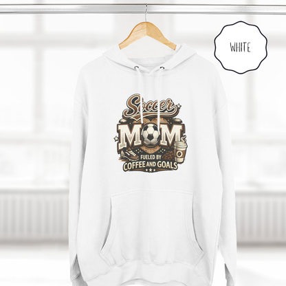 White soccer mom pullover hoodie hanging on hanger with fueled by coffee and goals print