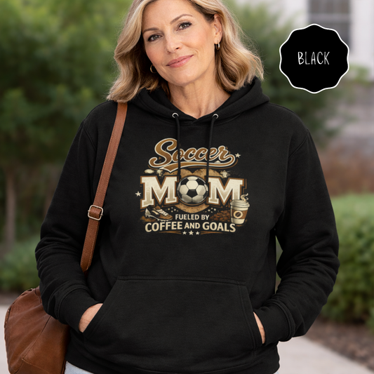 Middle aged woman wearing a black soccer mom hoodie fueled by coffee and goals