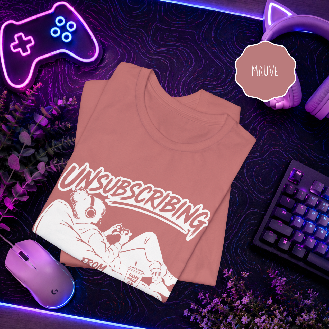 Gamer humor shirt mauve color flat lay neon gaming background
